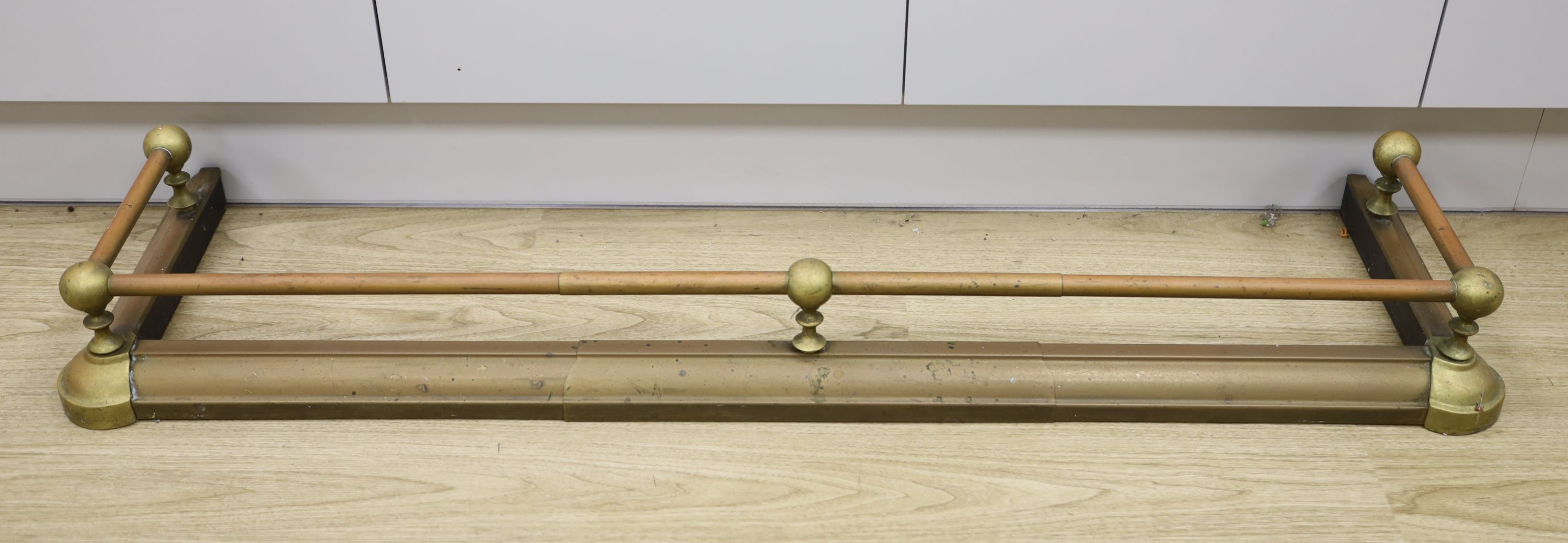 A brass fire fender, length 127cm